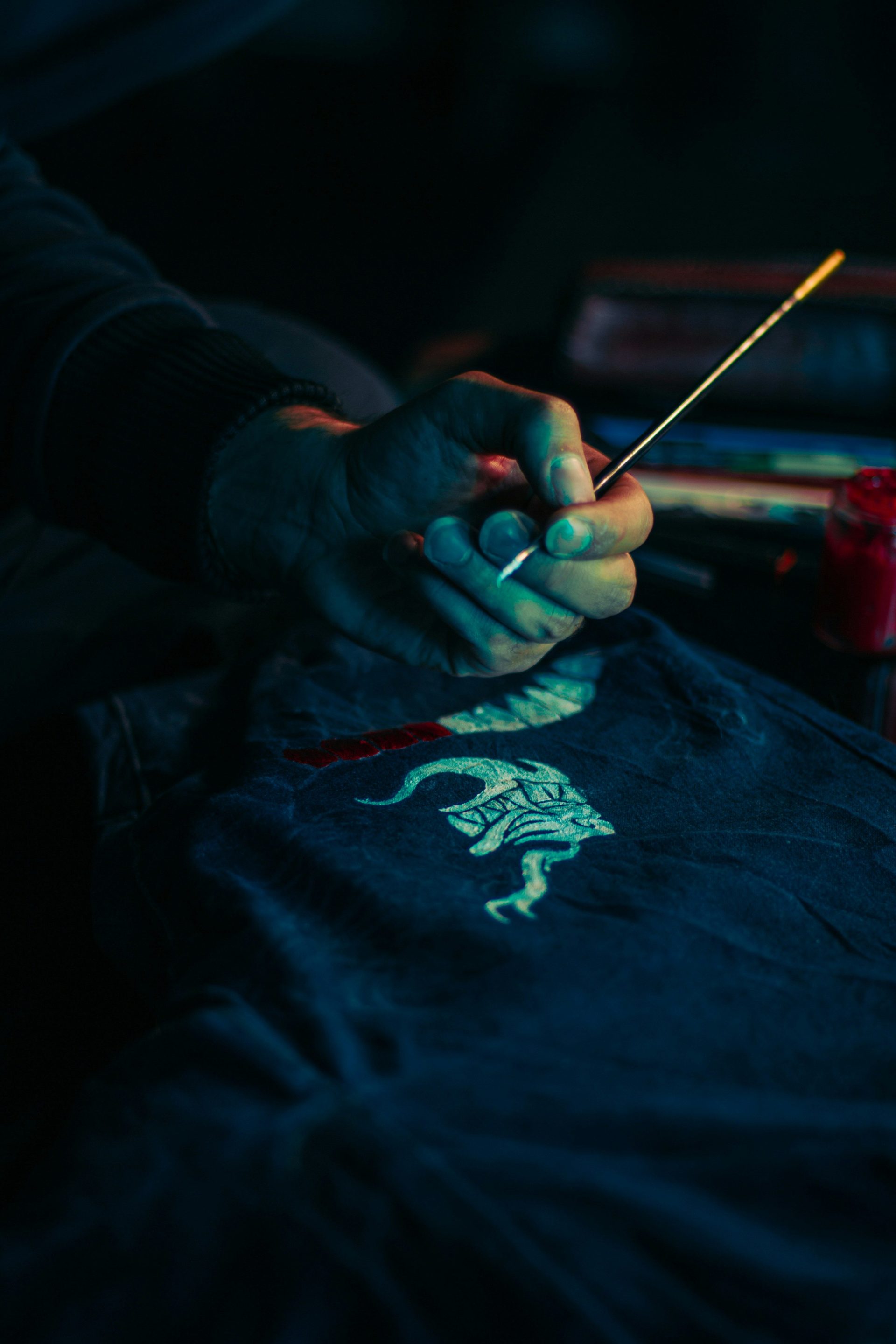 a person is painting on a t - shirt with a brush