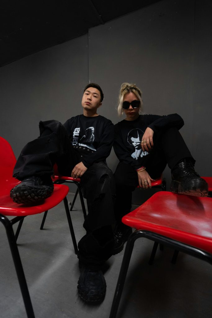 a couple of people sitting on top of red chairs